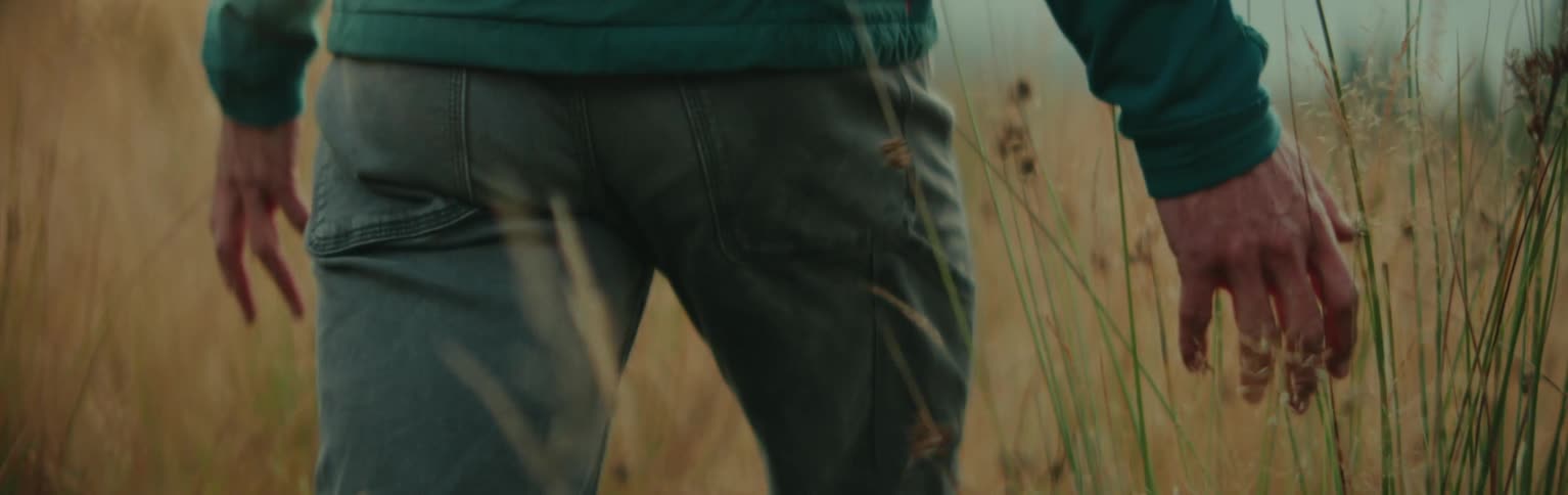 Man walking in a field of tall grass