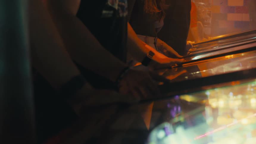 People playing on arcade machines