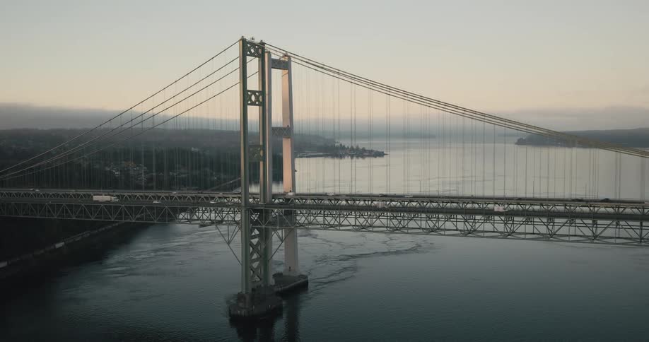 Aerial view of two long bridges over the ocean with vehicle traffic