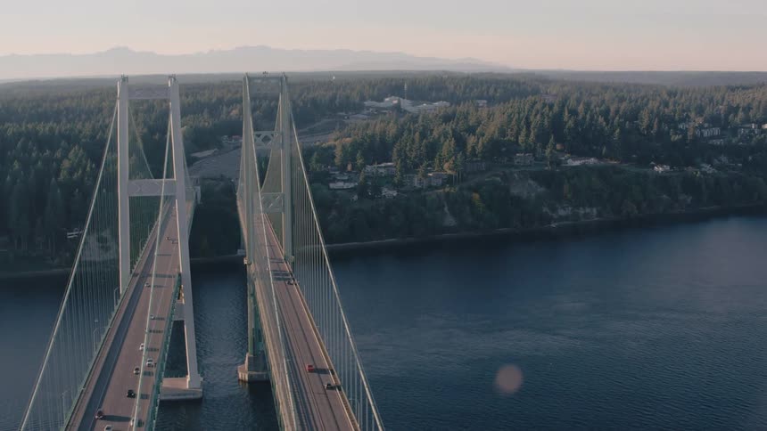 Aerial view of two bridges side by side with vehicle traffic over the sea