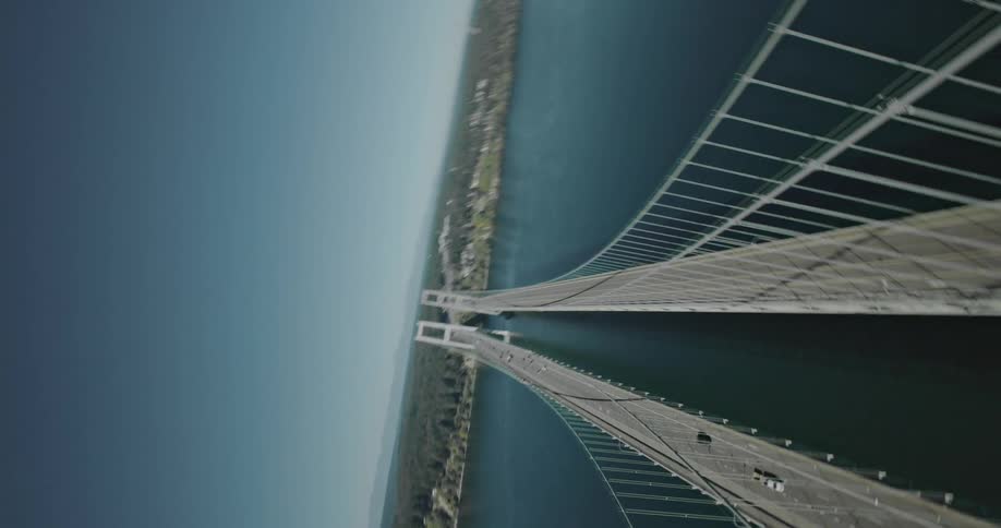 Aerial view of two large bridges stretching above sea level