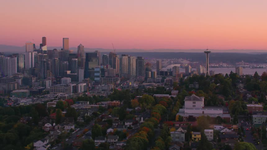 A panoramic view of seattle at sunset featuring the iconic space needle and the downtown area