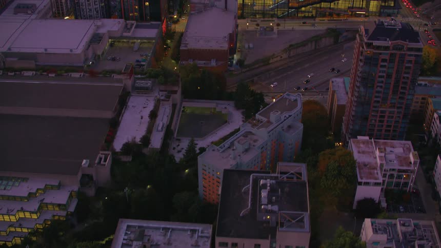 Aerial panorama at dusk of a metropolis and intersections with vehicle traffic