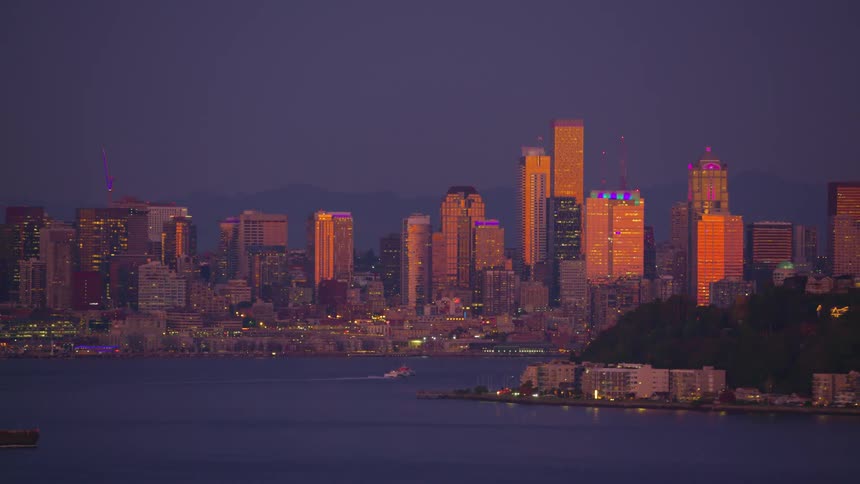 Aerial view of a seaside metropolis seen at dusk