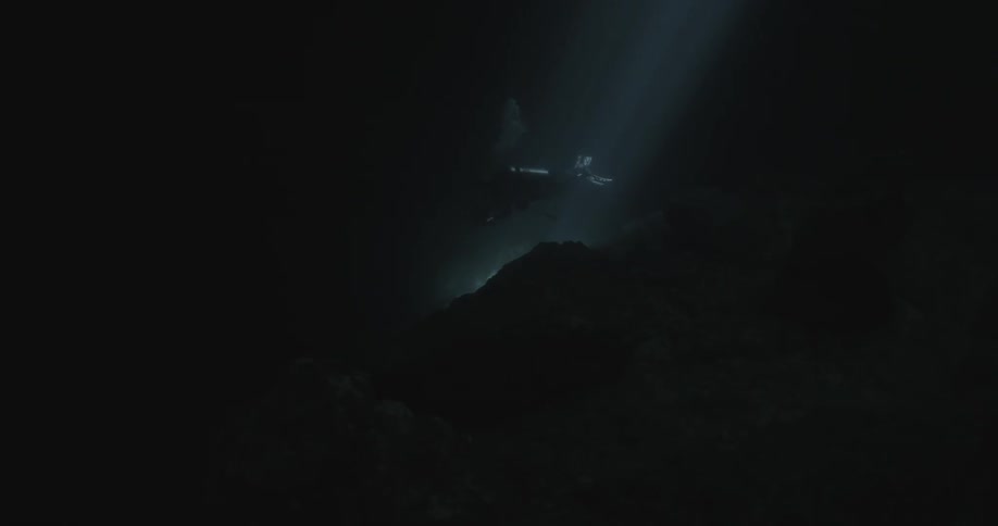 A scuba diver swims in deep water