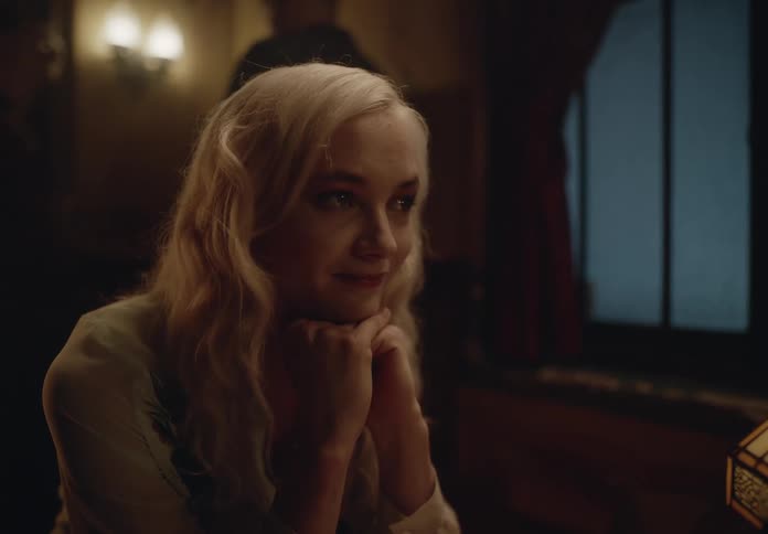 Portrait of a blonde woman with her hands on her chin in a bar talking