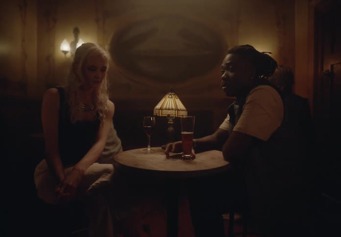Man and woman sitting at a table drinking wine and beer in a restaurant