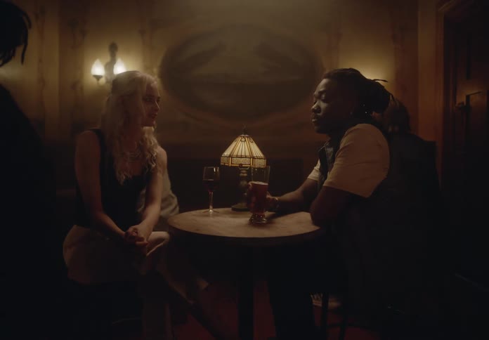 Woman and a man sitting at a bar table talking