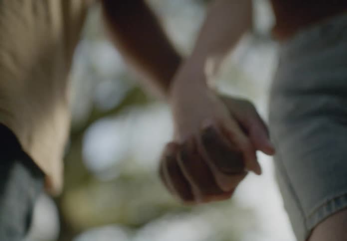 Close up of two people holding hands