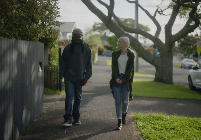 A clip of a man and a woman walking the street