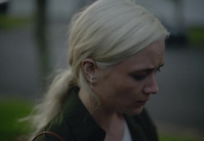 A woman looks sad as she is walking
