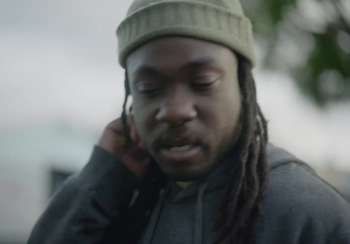 Portrait of a man with a cap on his head walking and talking