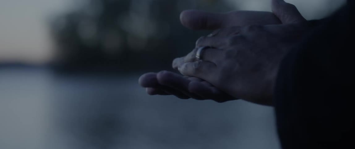Person rubs their hands together on a cloudy day