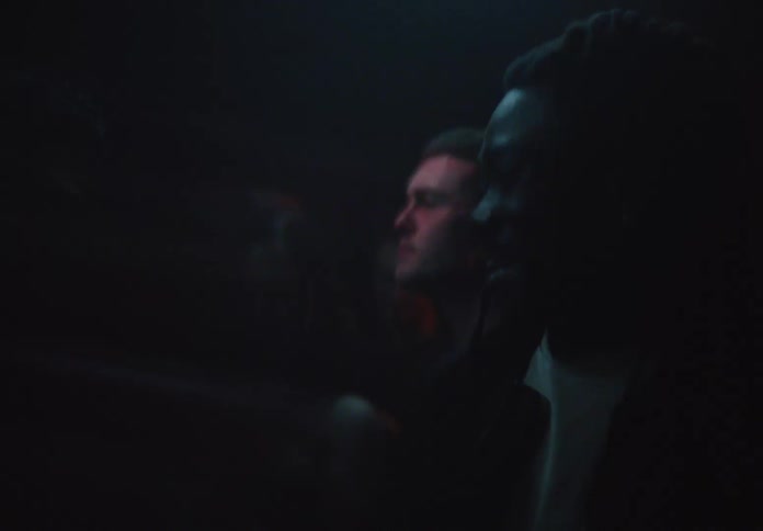A young man dancing in a packing club at night