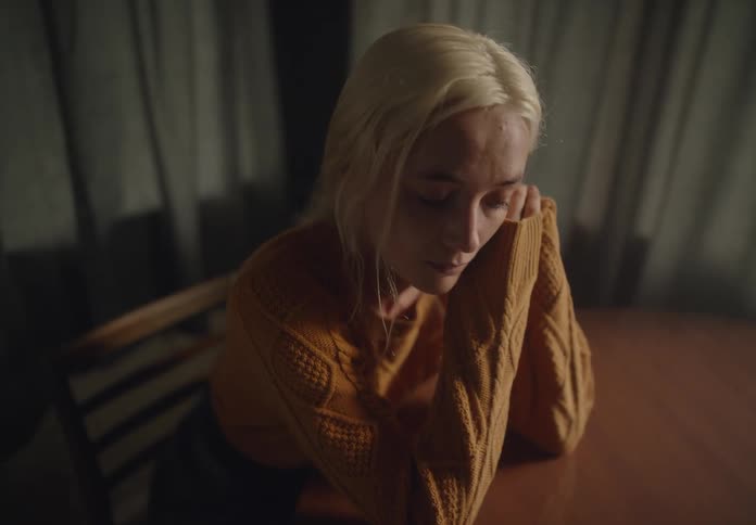 Young woman sitting at table crying