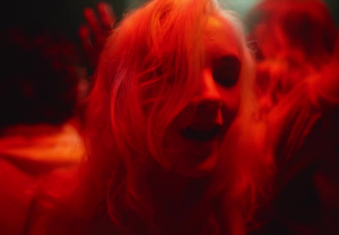 A group of people are dancing in the club
