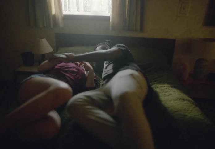 Happy couple running and throwing themselves together on the bed