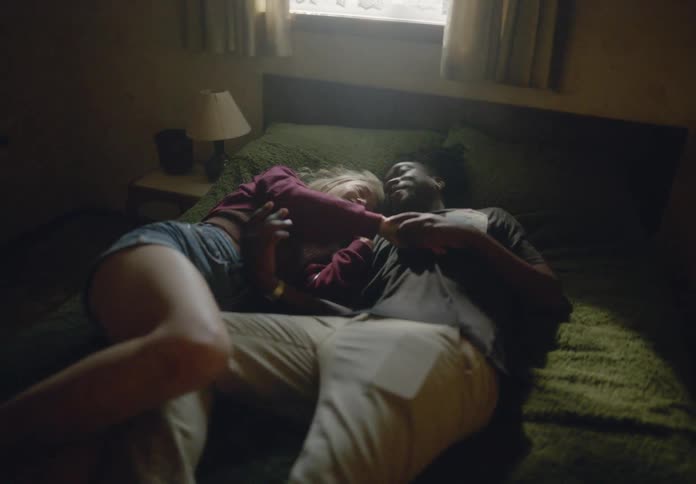 Woman and a man running and throwing themselves on the bed in the bedroom