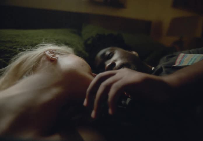 Affectionate couple lying together in bed