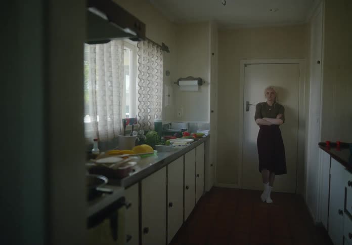 Woman in the kitchen with a mixture of discouragement and sadness