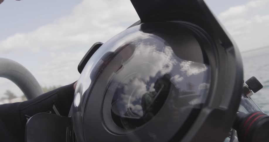 A man with sunglasses looking at an underwater camera
