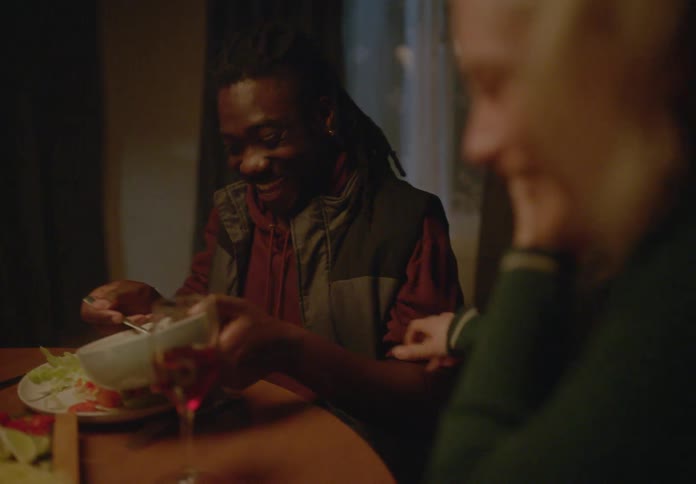 Woman and a man sitting at a table eating