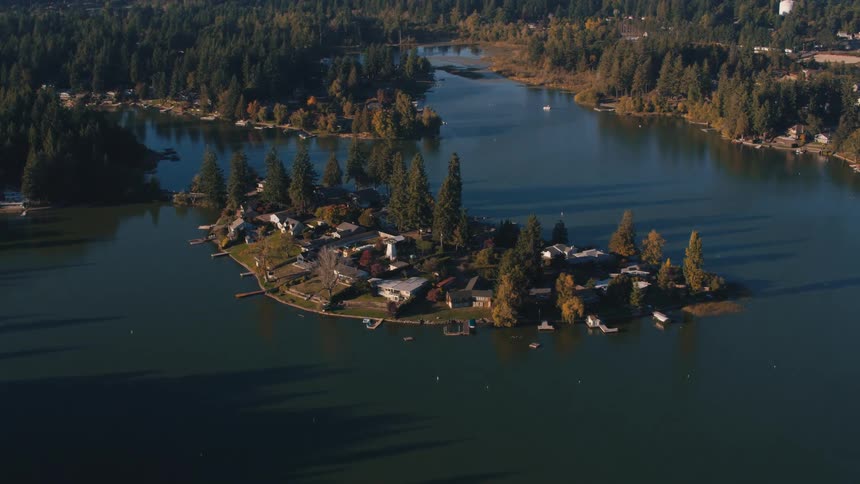 Aerial shot of an island surrounded by a lake with a residential neighborhood