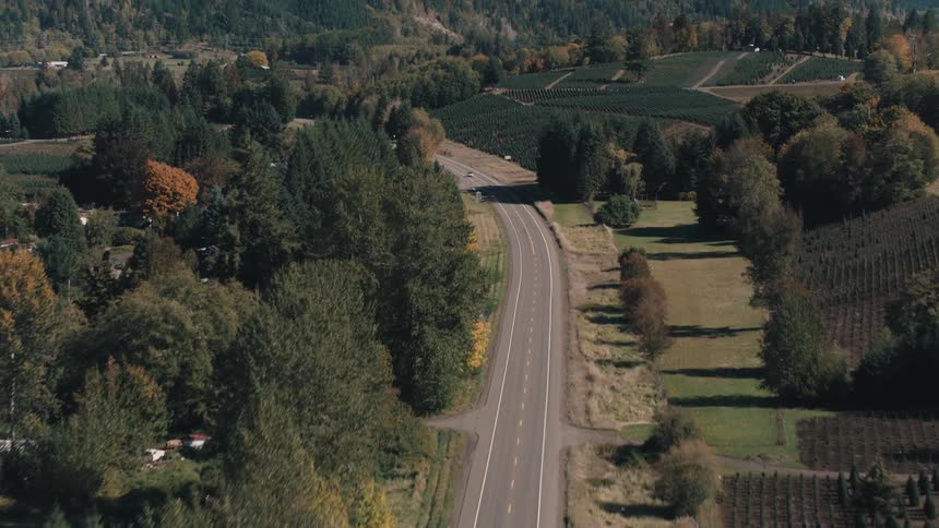 Highways and intersections with vehicle traffic in a location surrounded by forested mountains