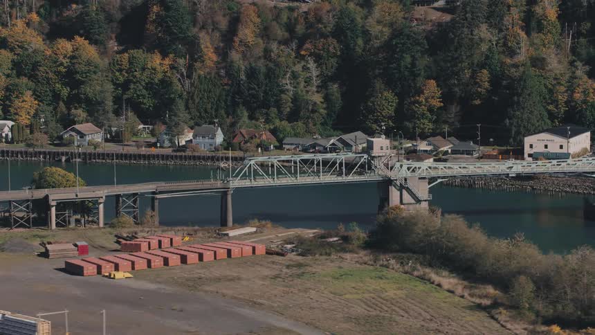 Bridge crossing a sea canal with residential houses in the background