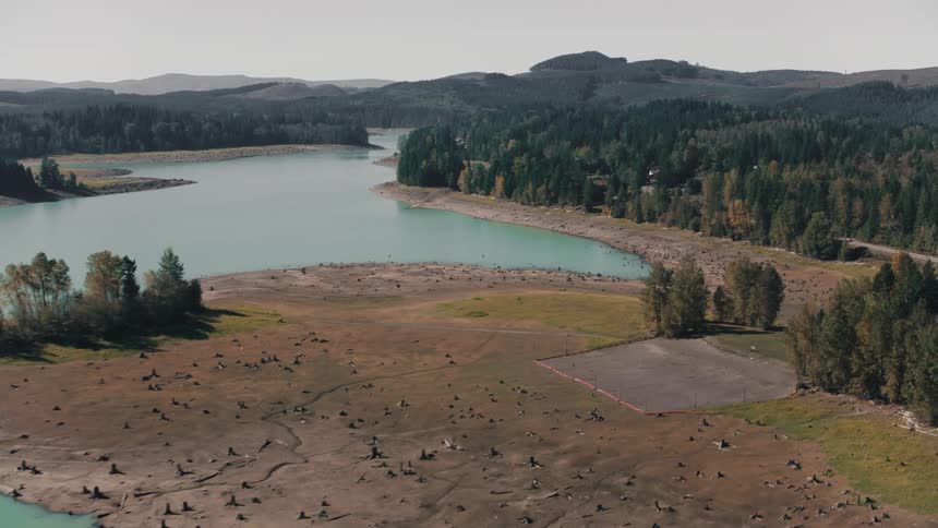 An areal clip of a lake in the woods