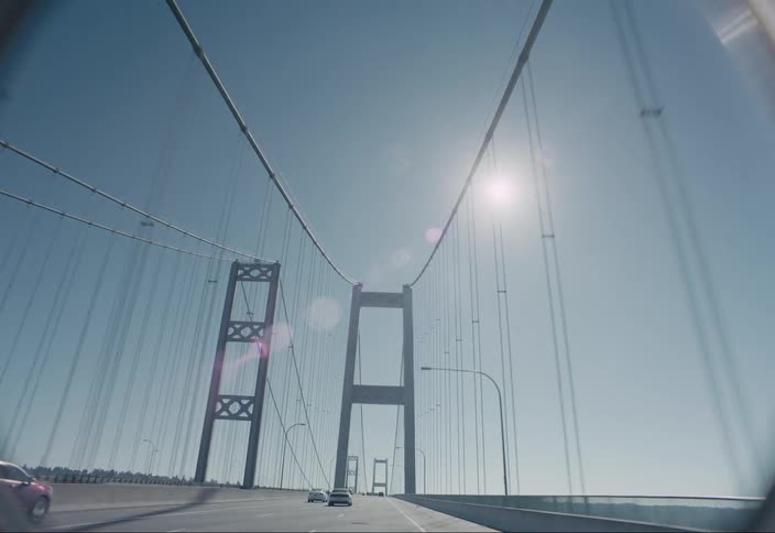 Moving view of vehicles moving across a bridge