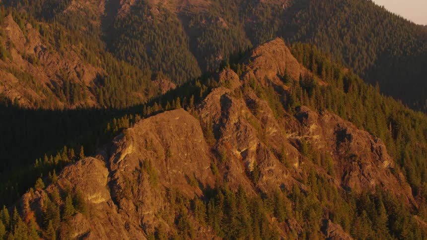 Aerial view of a rocky mountainous peak with vegetation