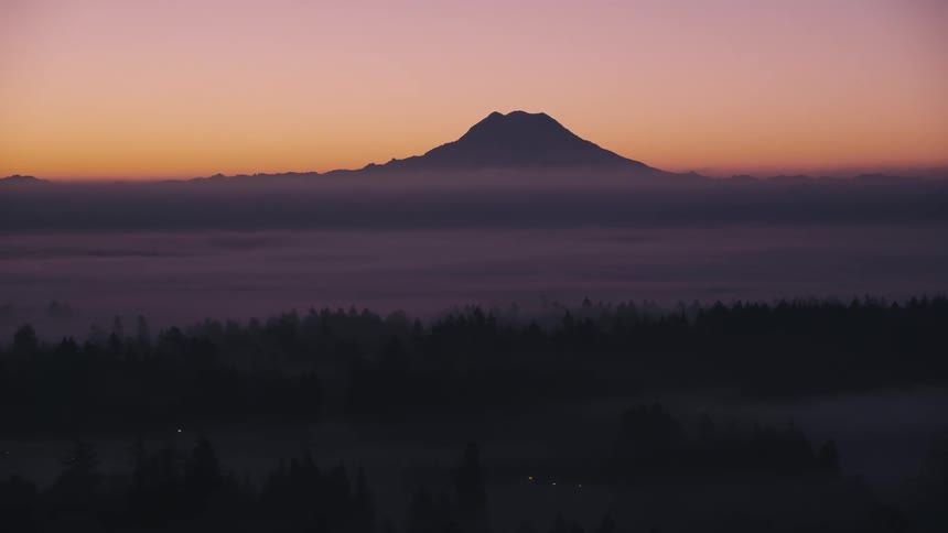Landscape of a sea of low clouds and an imposing mountain on the horizon
