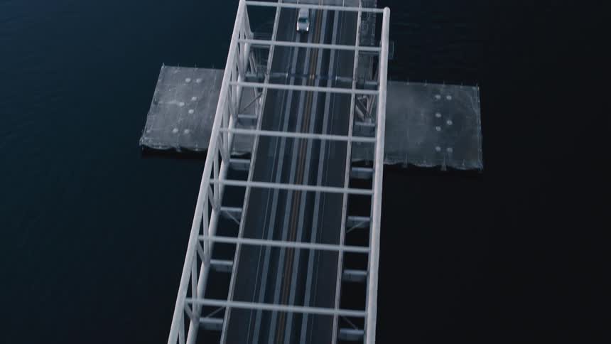 Vehicle traffic on a bridge above the sea