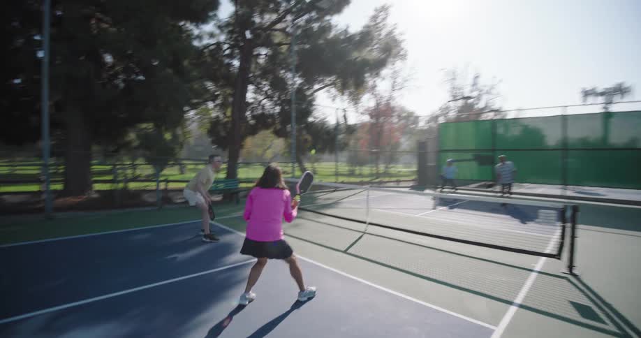 People are playing a game of pickleball