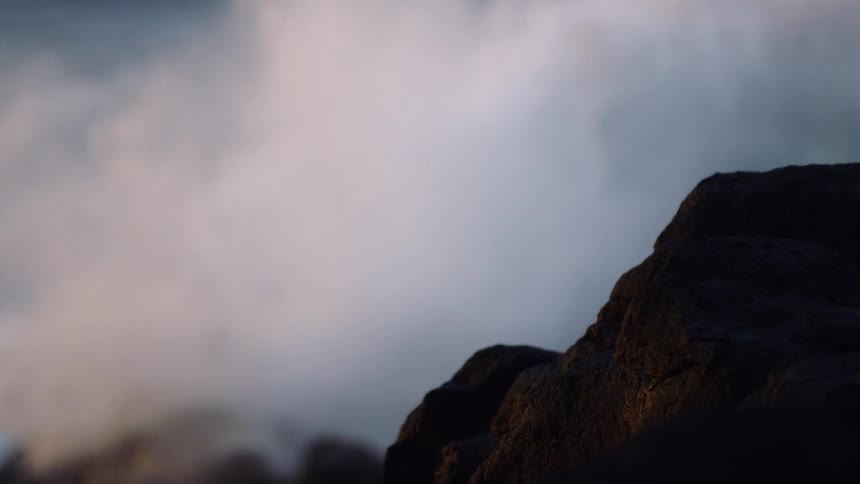 Waves carshing on large rocks in the ocean