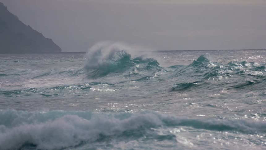A wave breaking close to the shore in a sea that is very rough