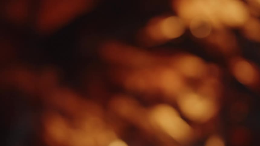 The gold bubbles are flowing upward and to the left against the black background