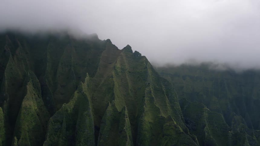 Mountainous valley with steep greenish peaks