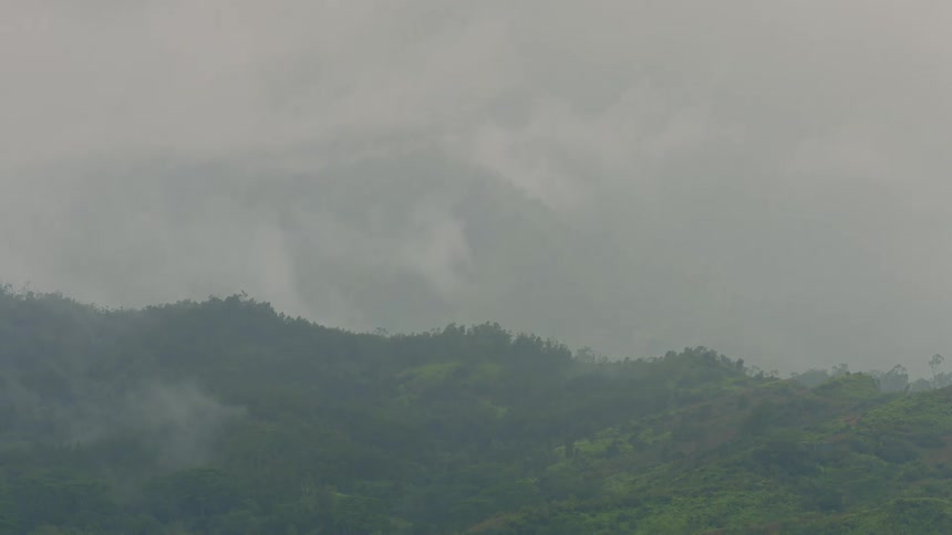 The camera is panning down on the mountain going down to the field