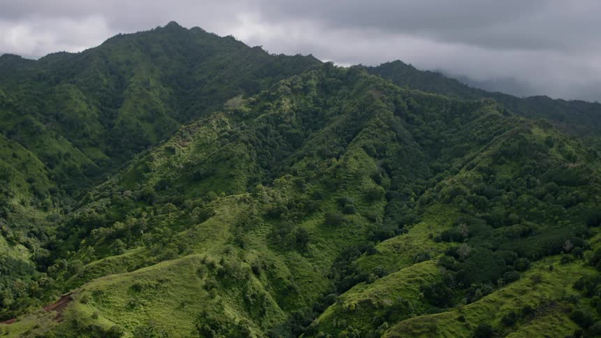 Aerial landscape of a greenish mountain range on a cloudy day