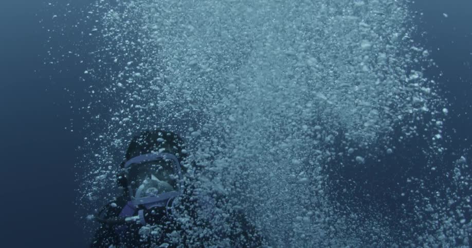 Bubble are streaming up around a diver underwater