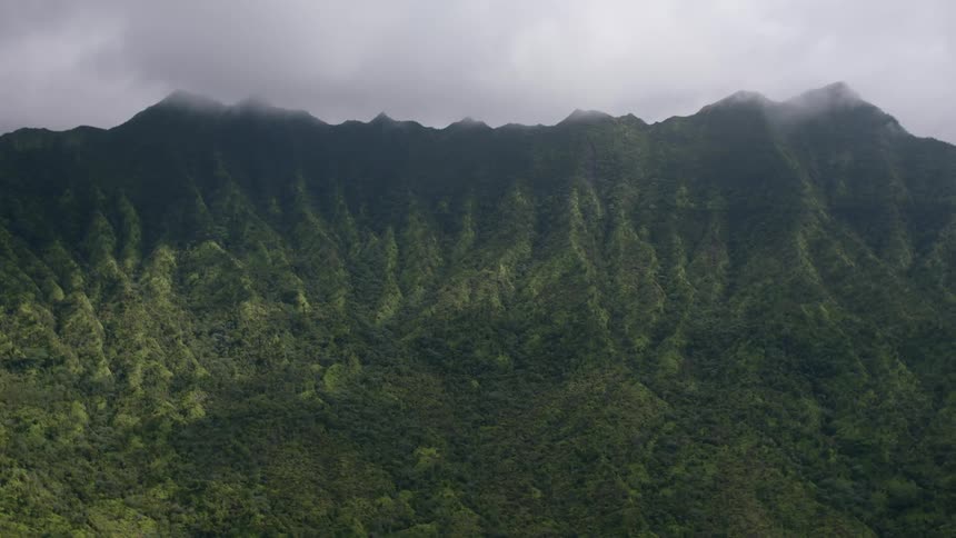 Aerial landscape of a greenish mountain on a cloudy day