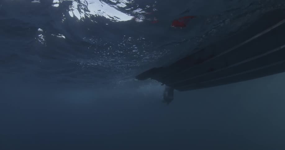 A boat passes by in the water above