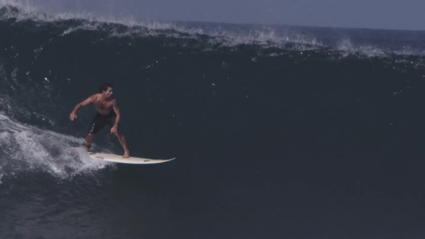 A man surfs on a sunny day