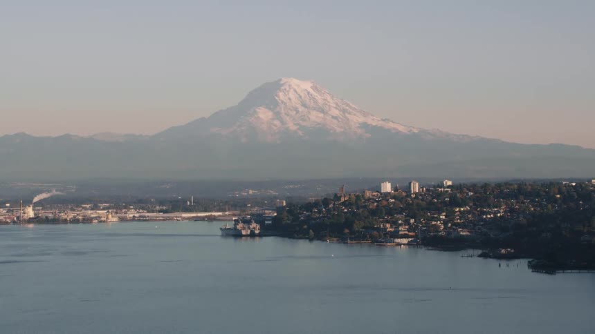 A small city sits near a huge mountain