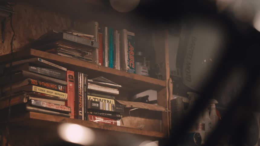 Books stored on a wooden shelf on the wall