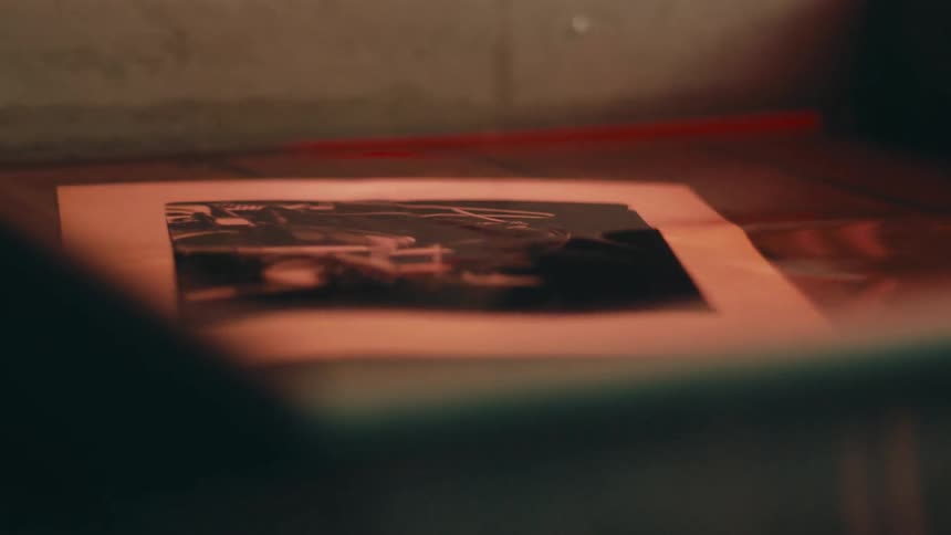 Photograph floats in a tray of developing fluid