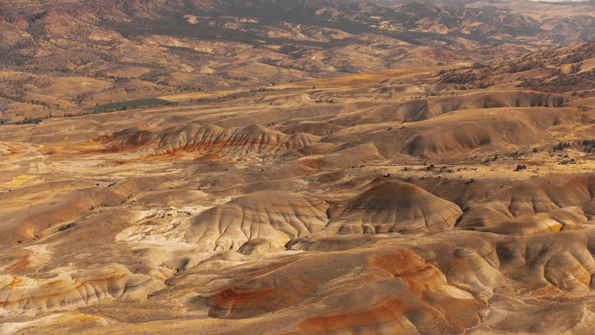 Aerial panorama of barren hills and mountains against a cloudy sky