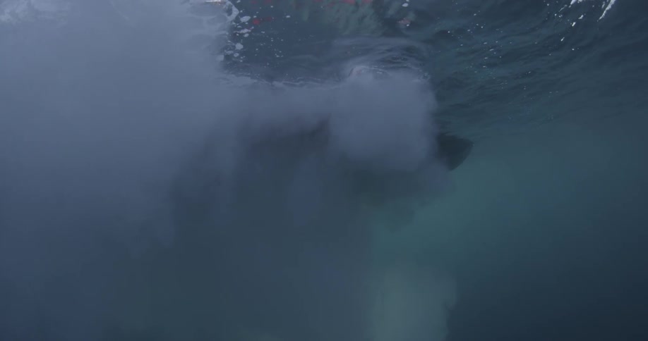 A boat travels in the water giving off bubbles
